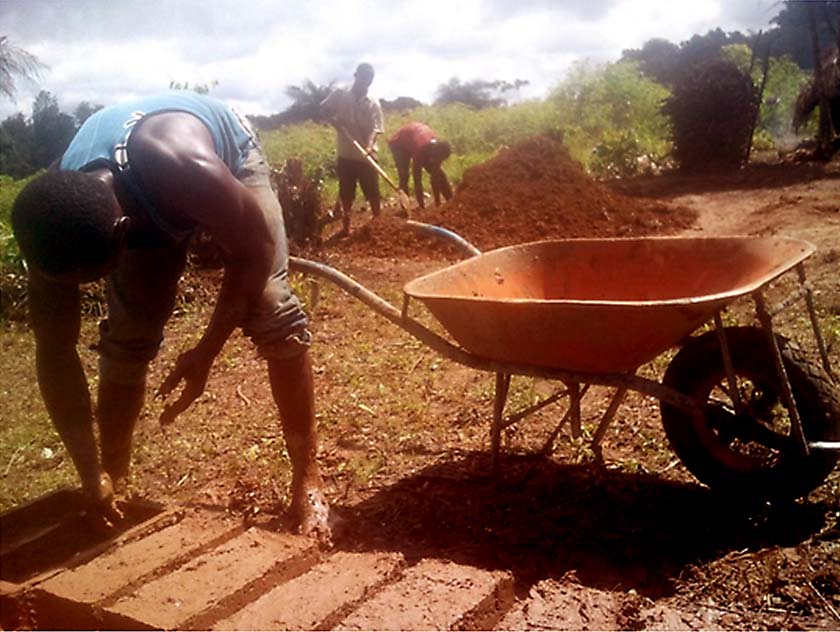 Former child soldiers in Liberia making bricks, reintegration program