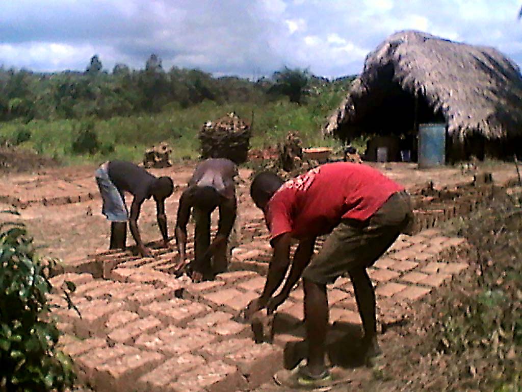 Former child soldiers in Liberia working with bricks, reintegration program