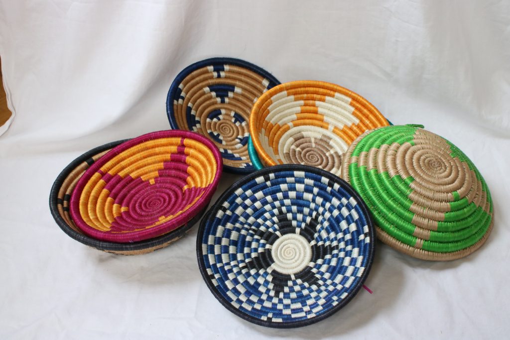 Colorful African bowls on the white tablecloth, products from one of the Action10 programs