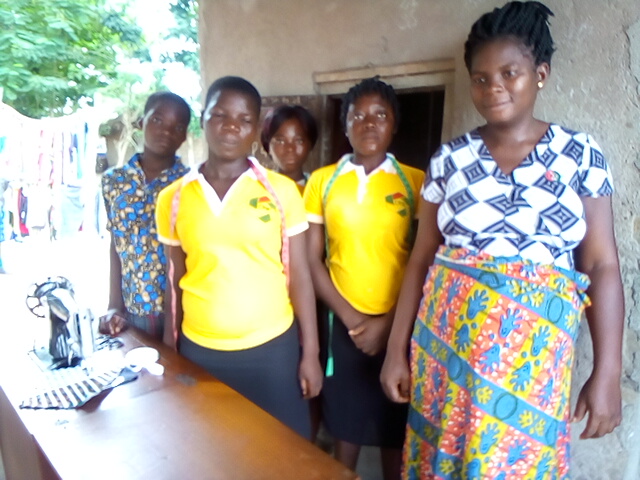 A woman teacher and girls students in the tailoring school in a Togo village